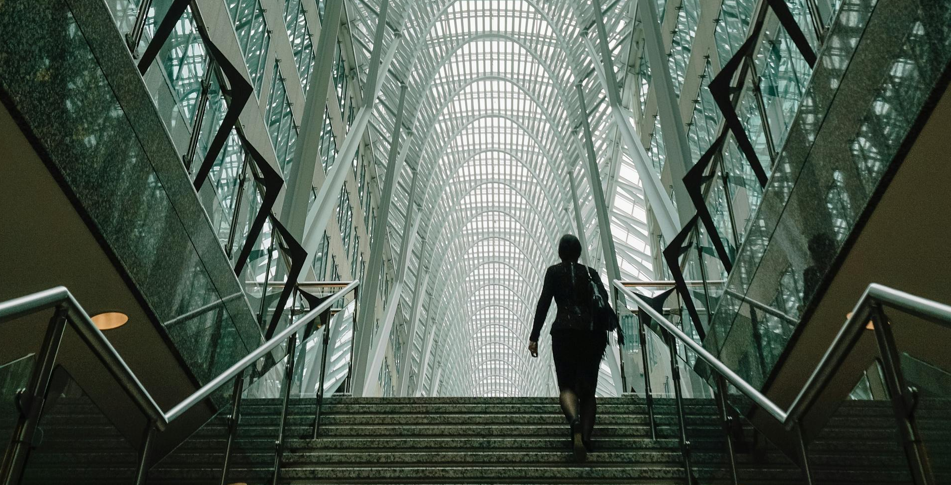 A woman walking up a staircase in a conference building